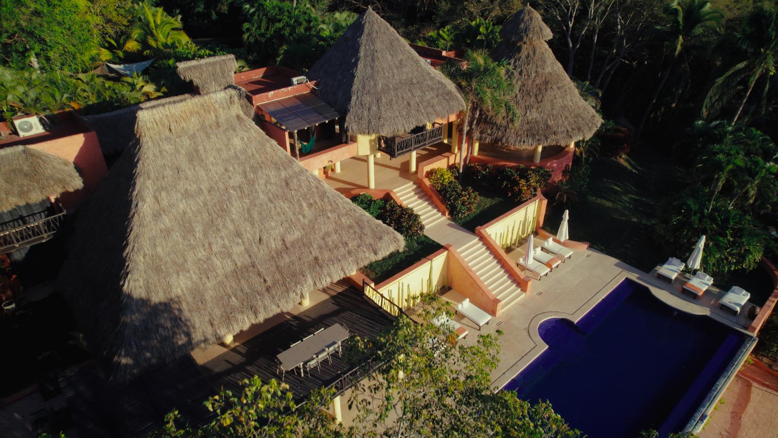 Aerial view of the Villa 2 pool deck and palapa roofs