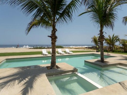 Villa 3 pool with palm islands and the beach behind