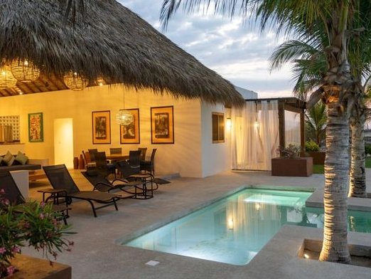 Villa 3 pool terrace and open palapa lounge at dusk